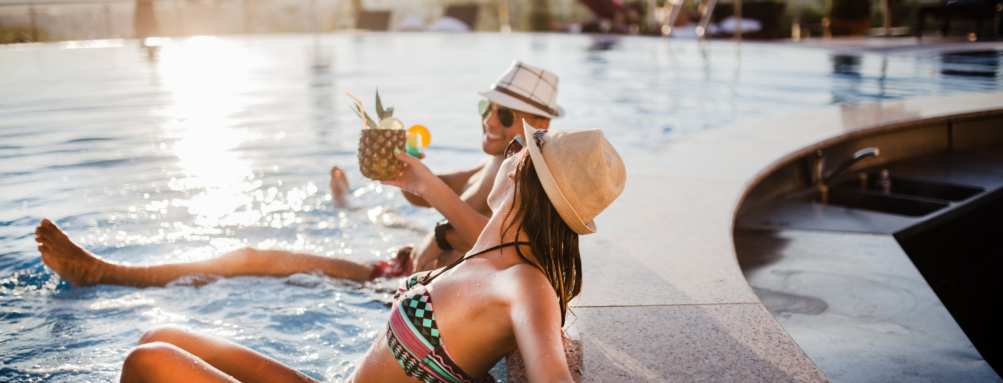 Couple enjoying luxury pool on holiday